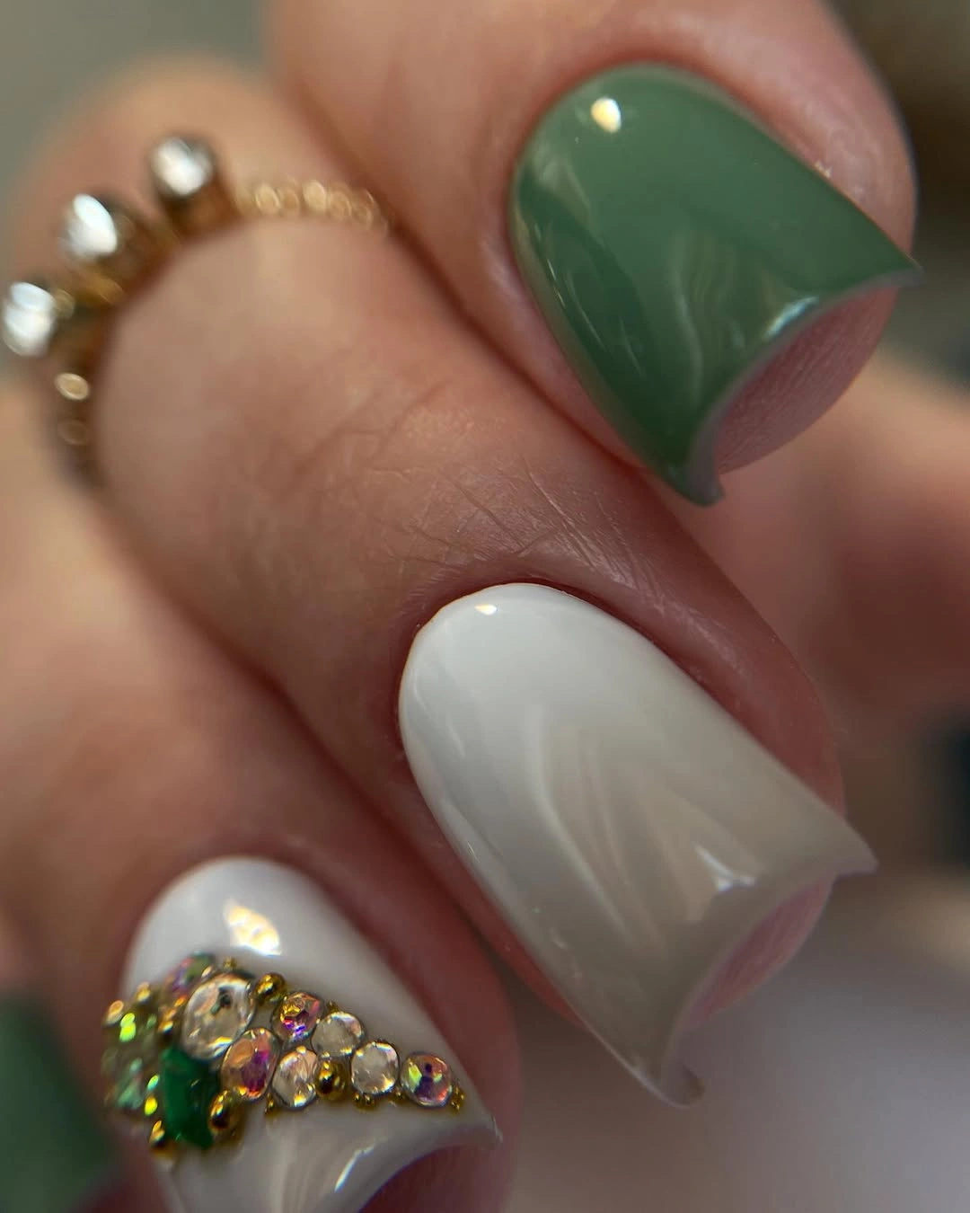 mixed green white rounded nails with small gold botanical detail