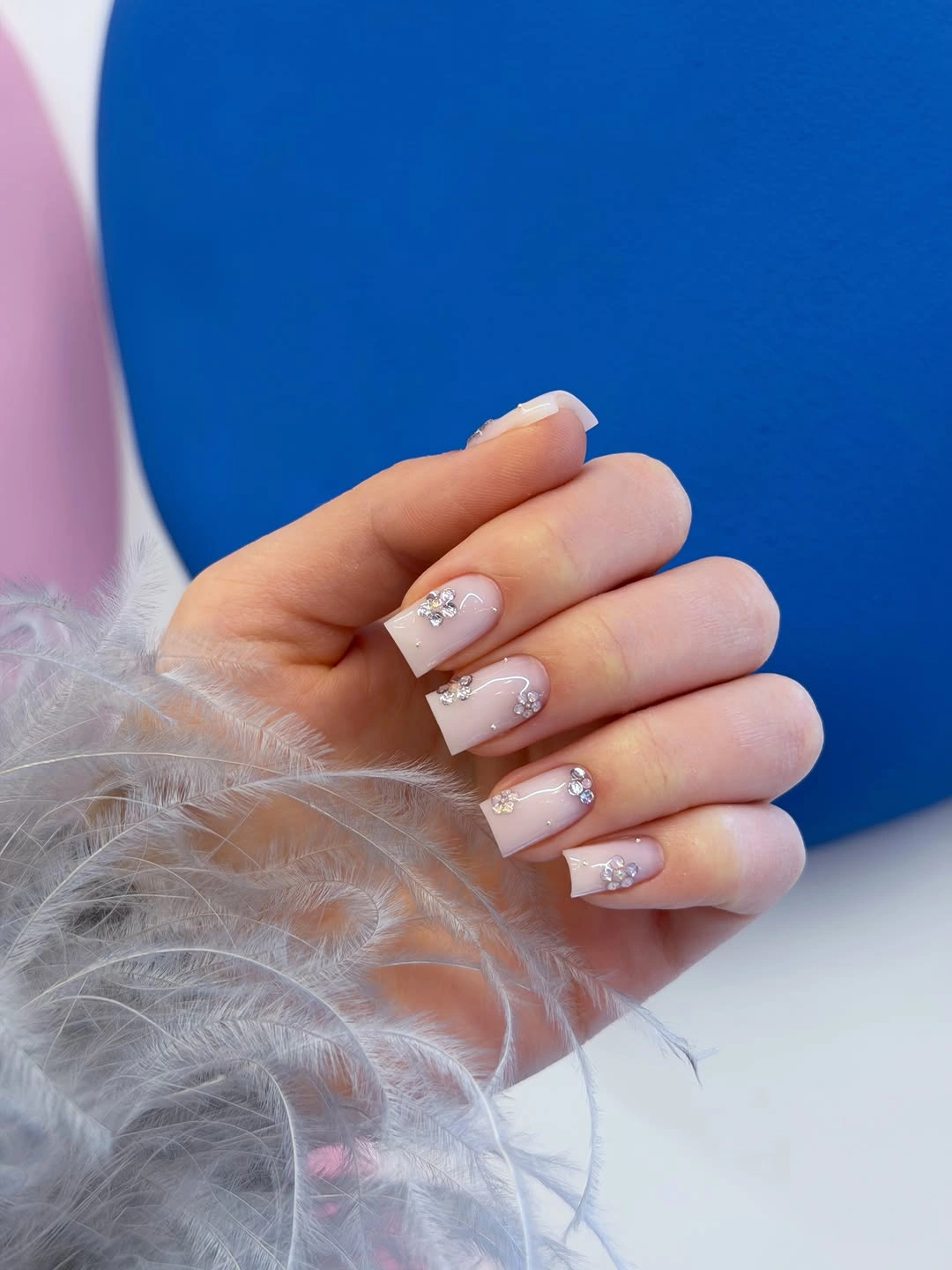 soft white medium nails with tiny light-catching accent