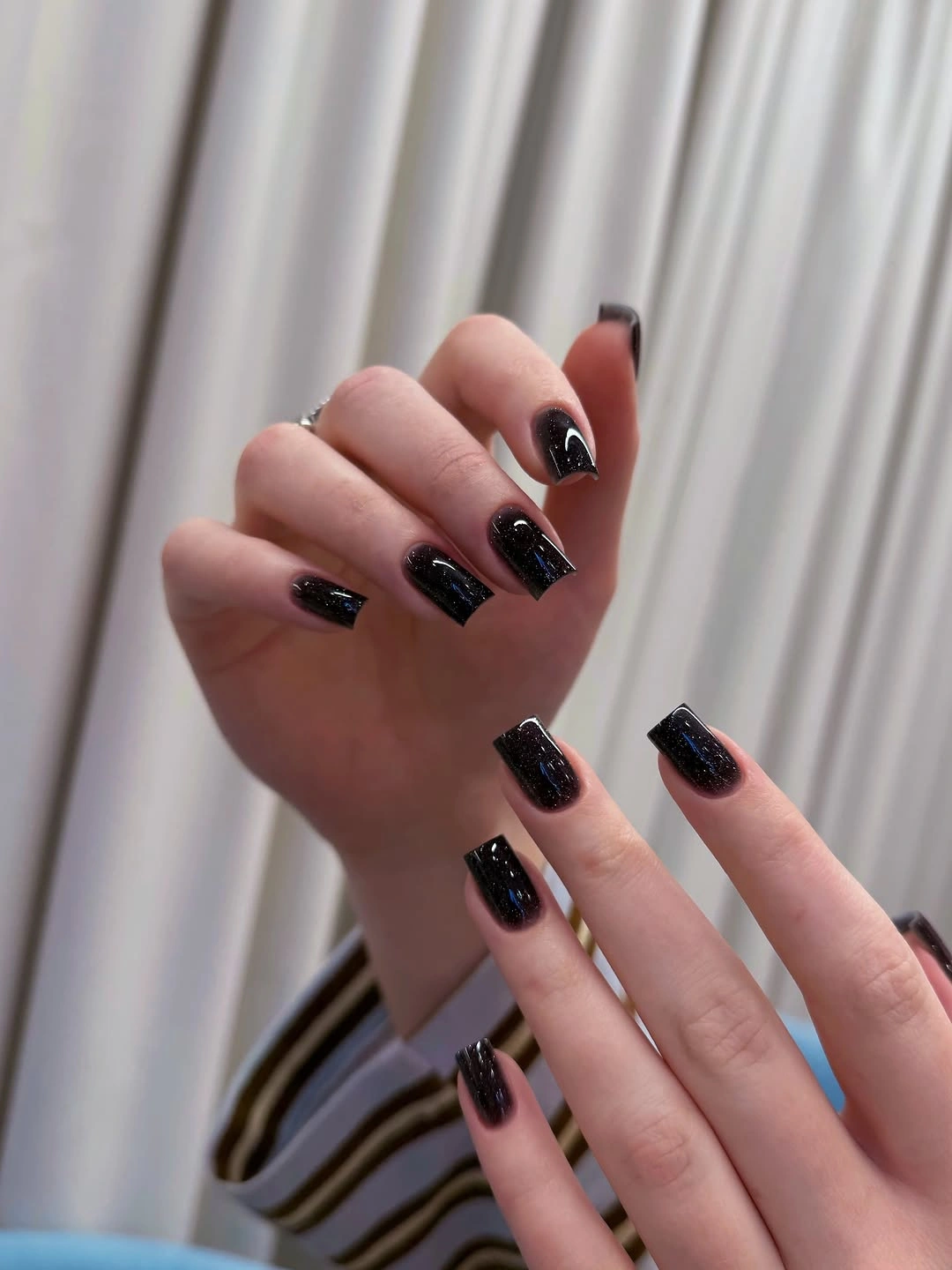 glossy black short square nails with small accent