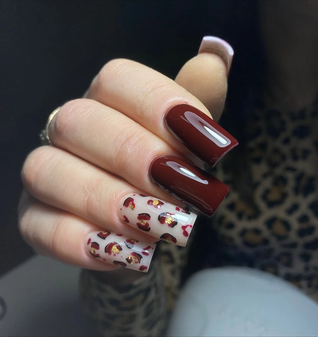 Burgundy square nails with one tiny seasonal doodle accent