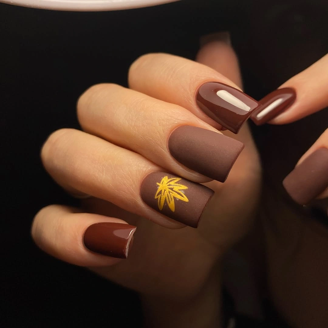 Matte cocoa square nails with a small gold leaf accent