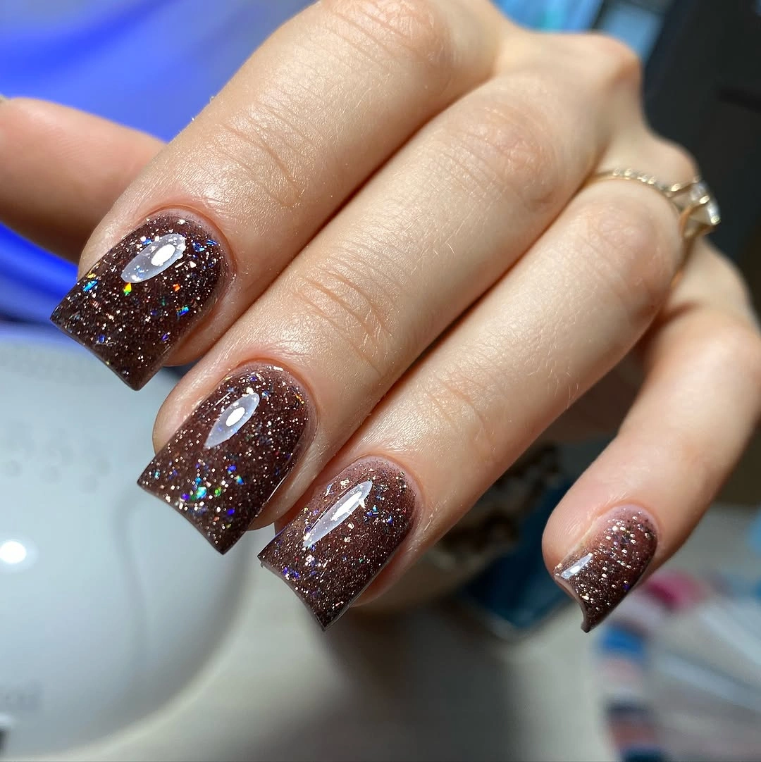 Brown square nails with multicolor glitter accents