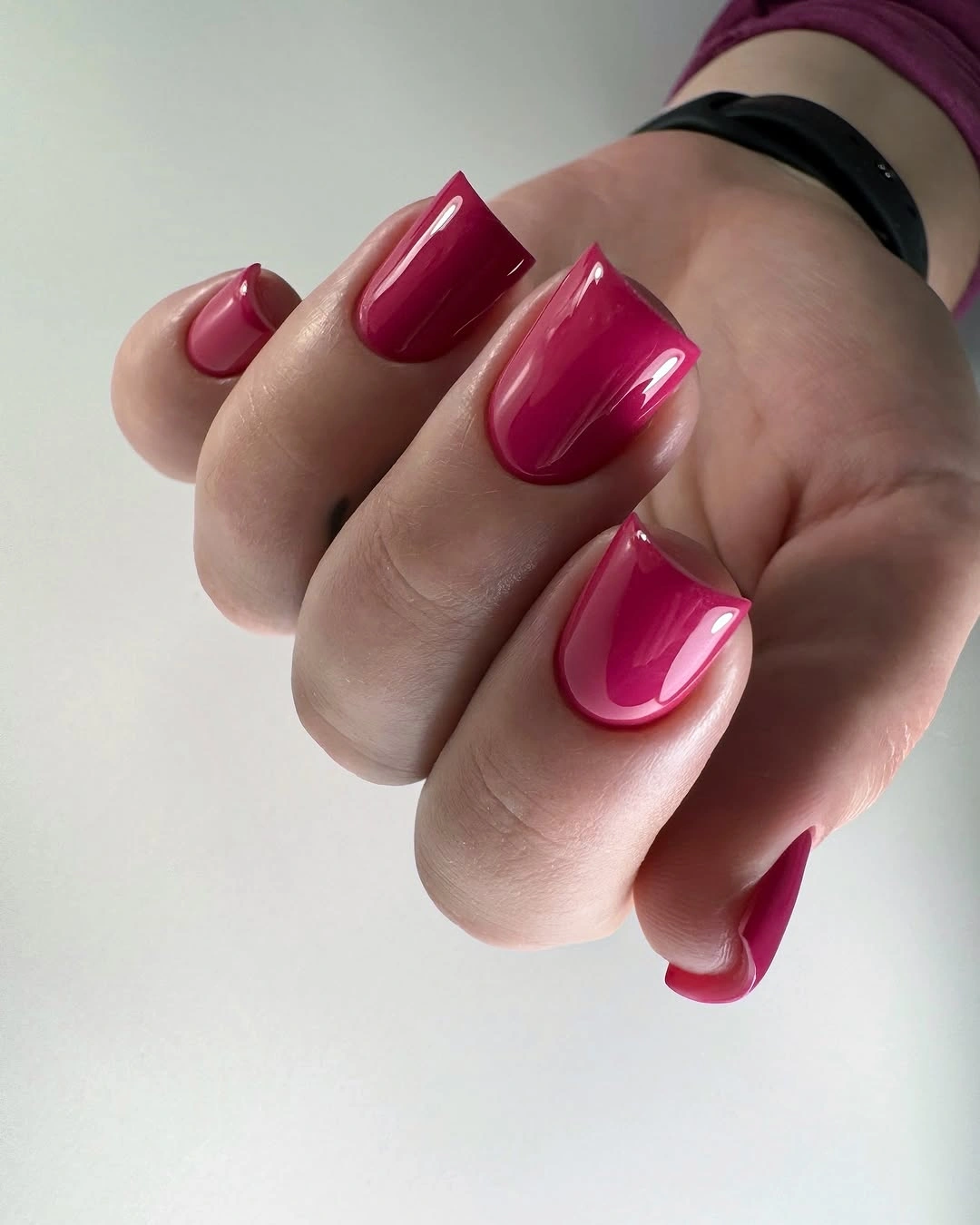 Glossy berry red almond nails with a warm fall tone