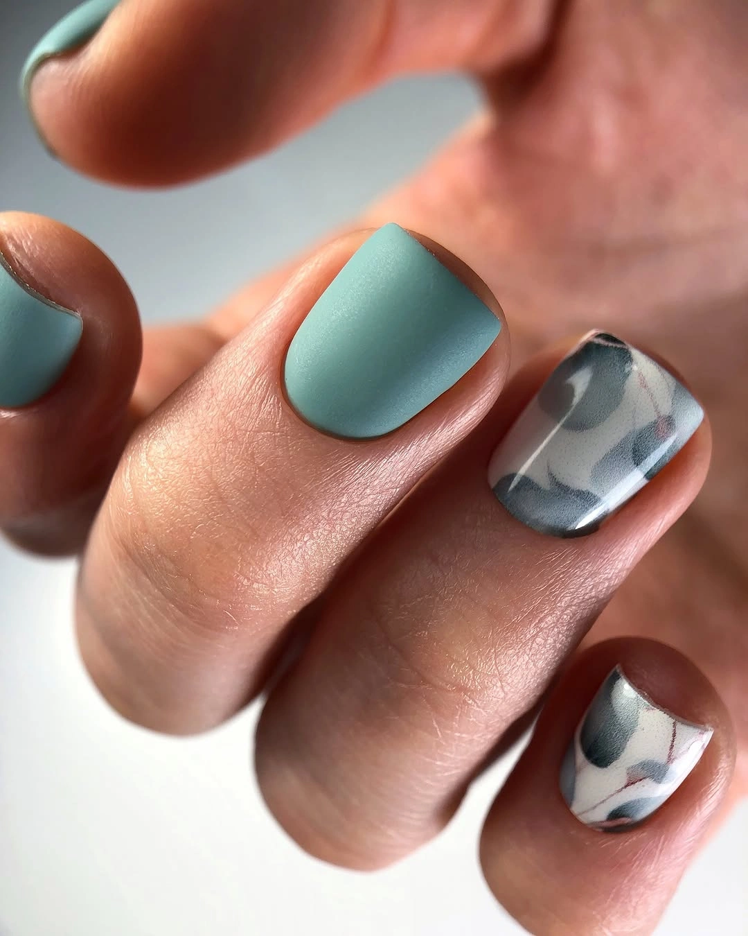 Muted sage nails with smoky gray marbled accents