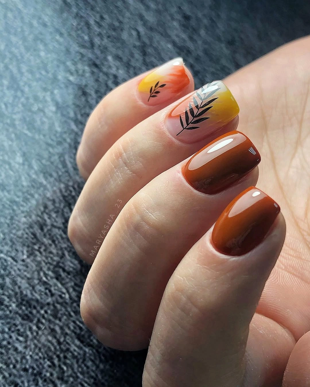 Short brown nails with orange autumn flower accents