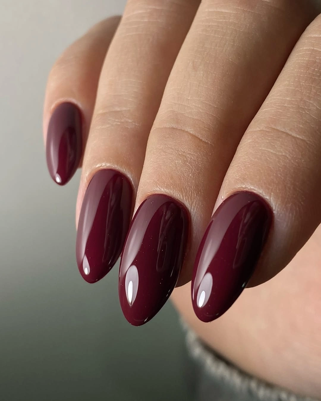 Medium almond nails in glossy deep burgundy