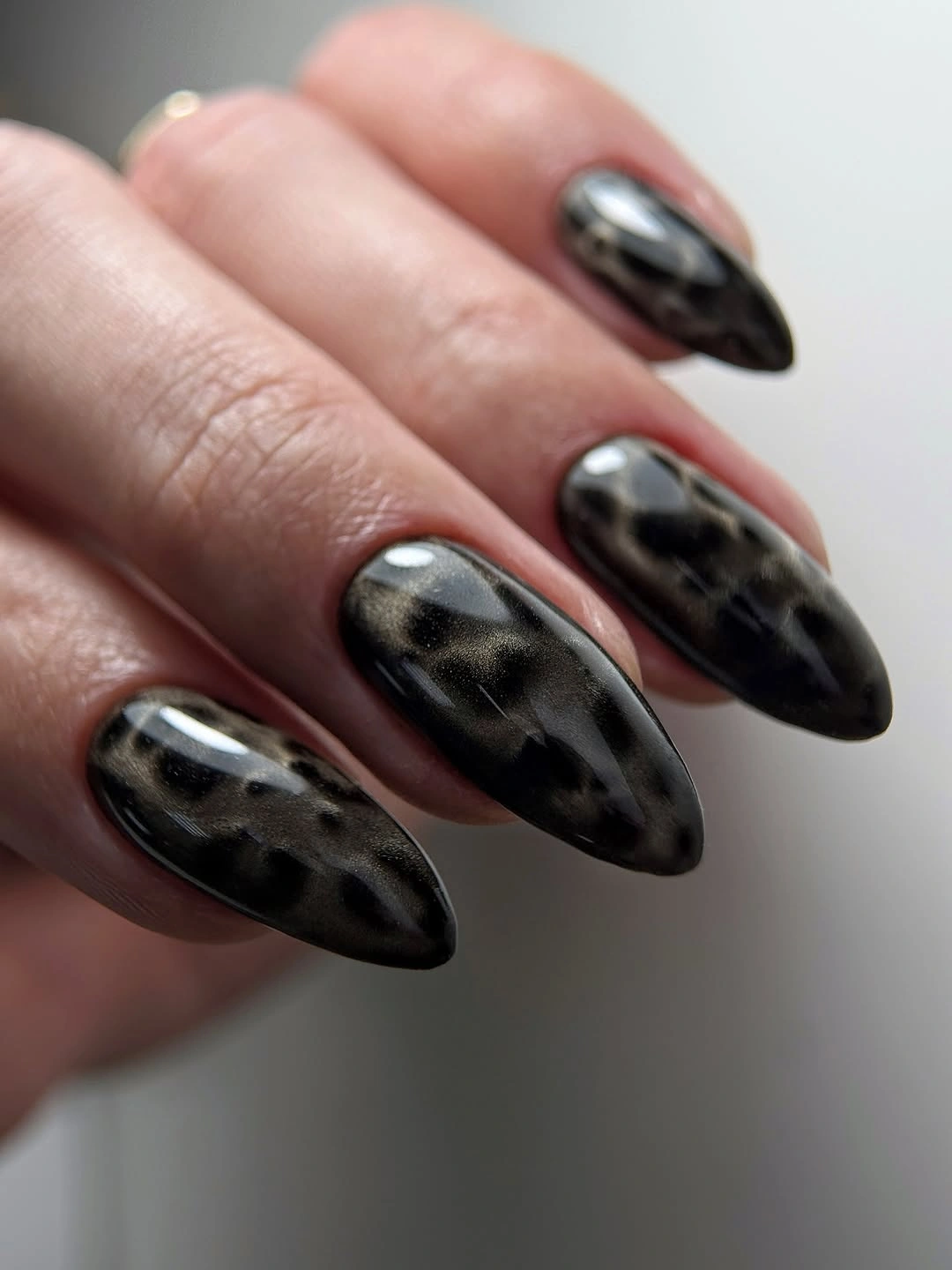 Medium black almond nails with soft gray abstract patches