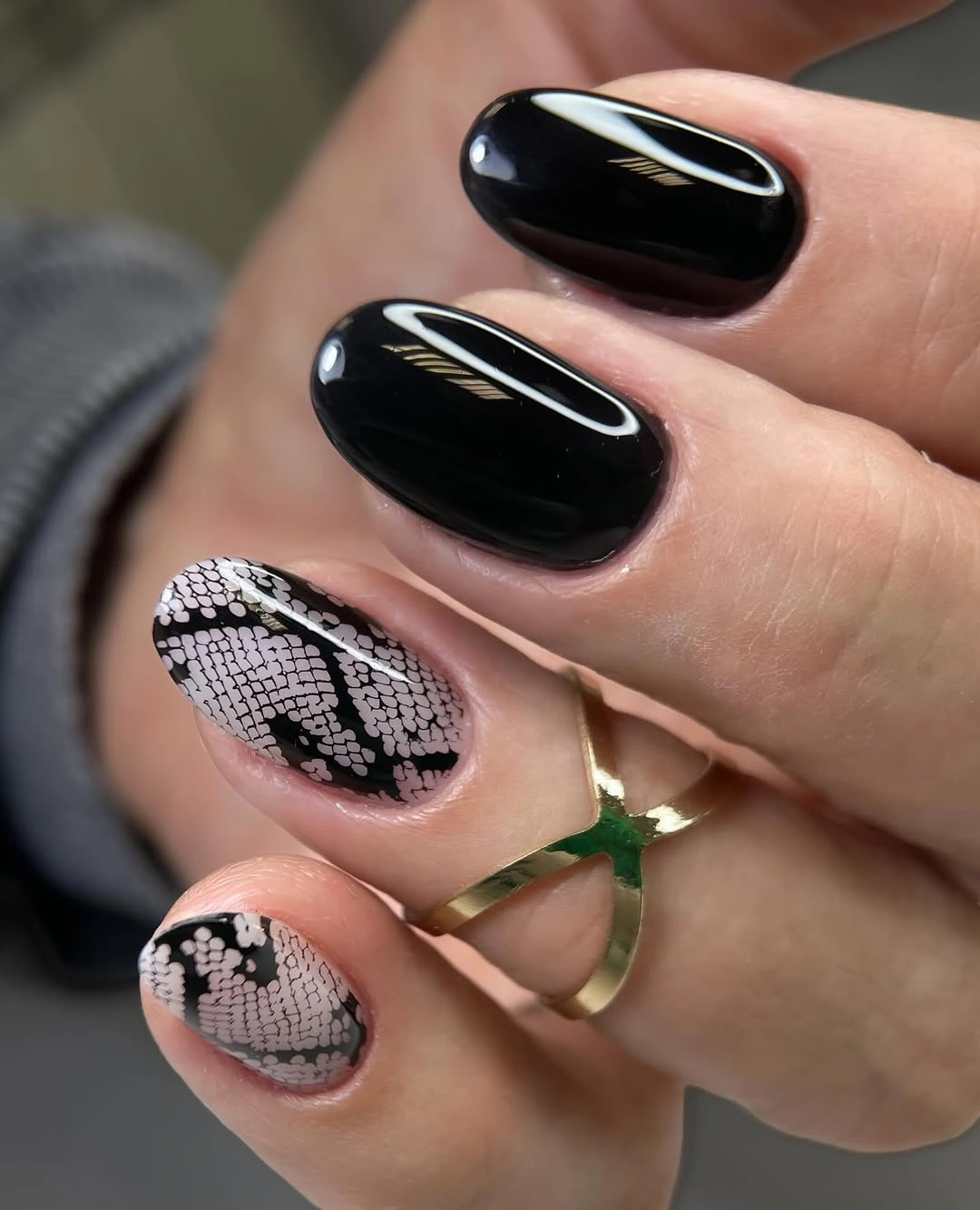 Short black nails with pale repeated-pattern accent nails