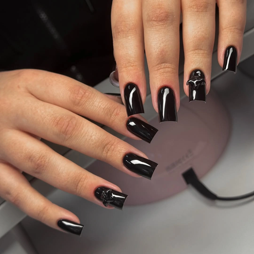 Long tapered black nails with tiny red and white accents