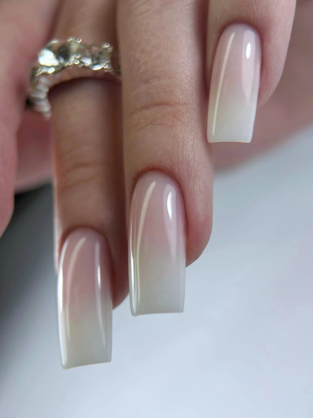 Very long tapered nails in glossy milky white