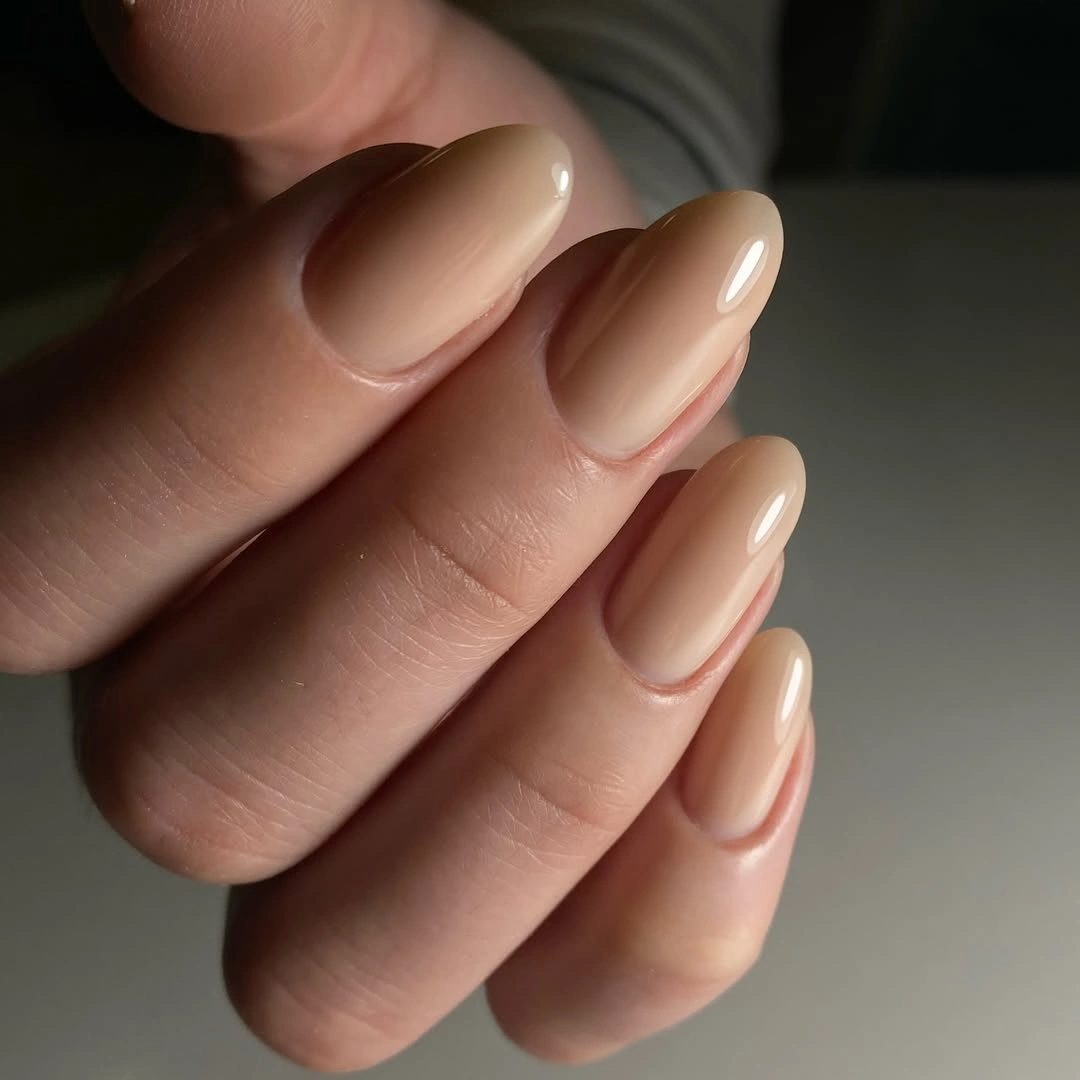 Warm beige nude nails in a medium almond shape
