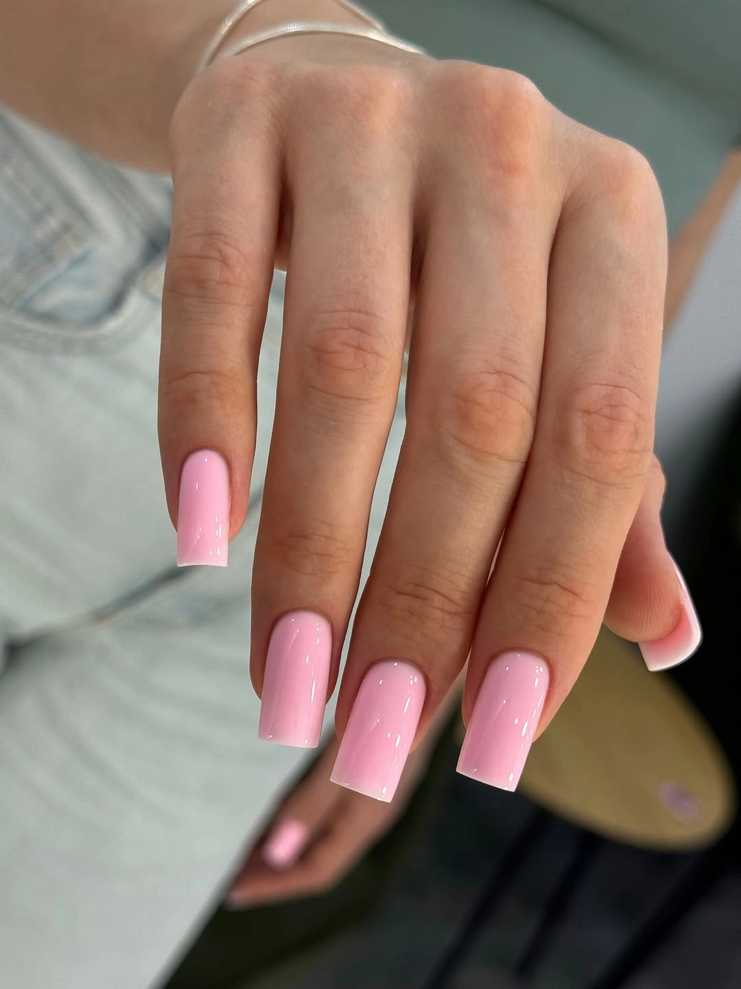 Medium almond red-orange nails with small illustrated accents