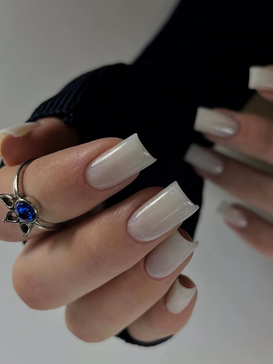 Short olive-brown nails with dimensional metallic accents
