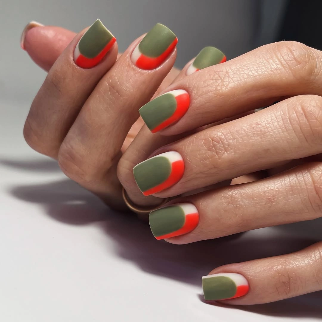 Short olive nails with vivid orange French-style edges