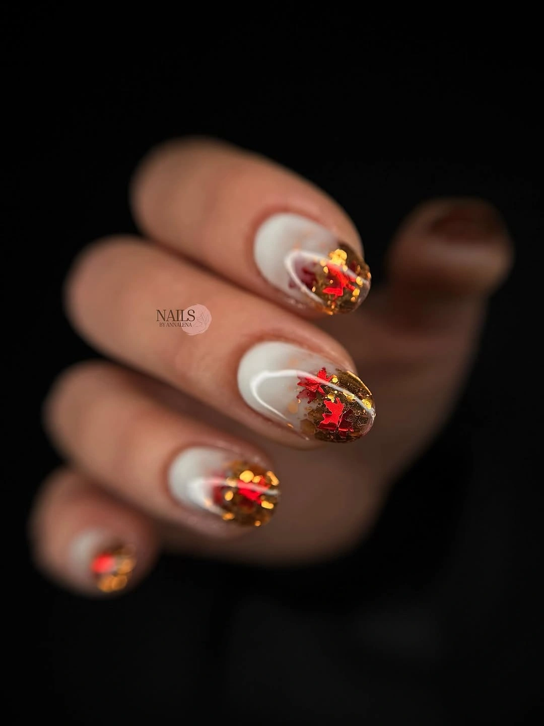 Milky almond nails with clear tips and warm gold accents