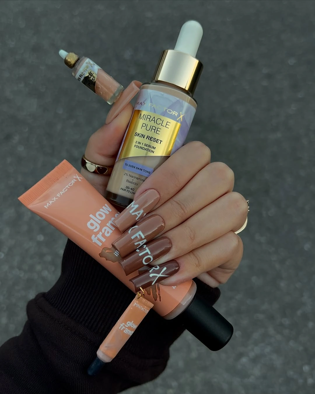 Pale nude nails with subtle fine accent marks and lettering