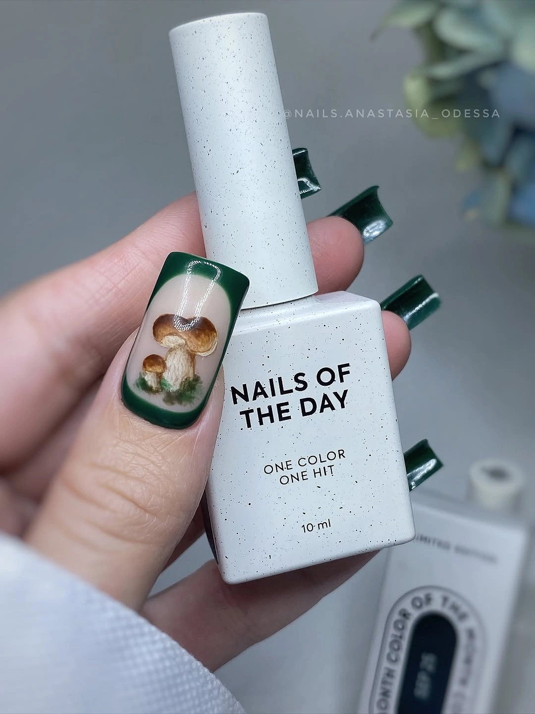 Deep green square nails with one warm botanical accent