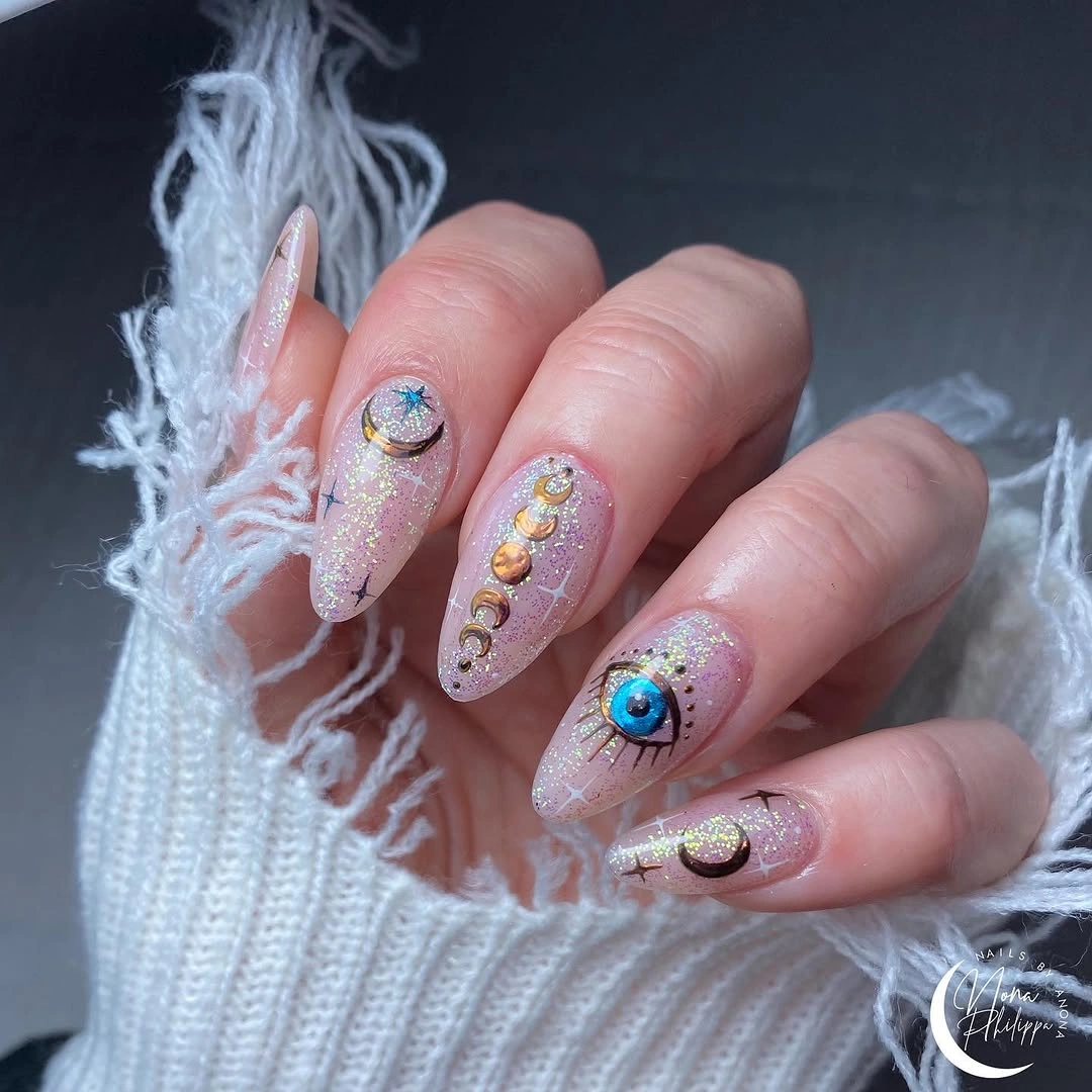 Pearly pink almond nails with gold blue circular accents