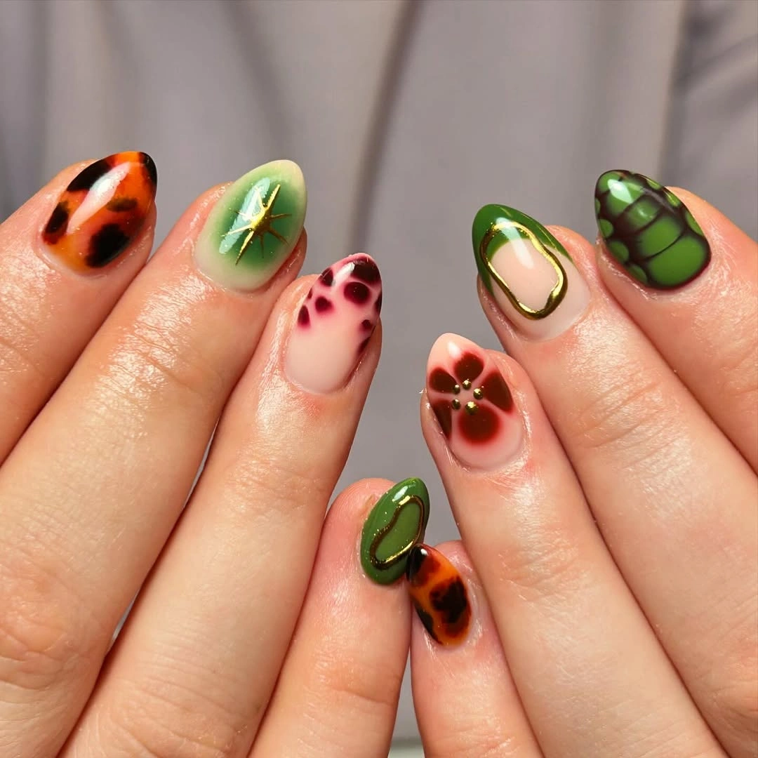 Mixed green orange and brown oval nails with varied accents