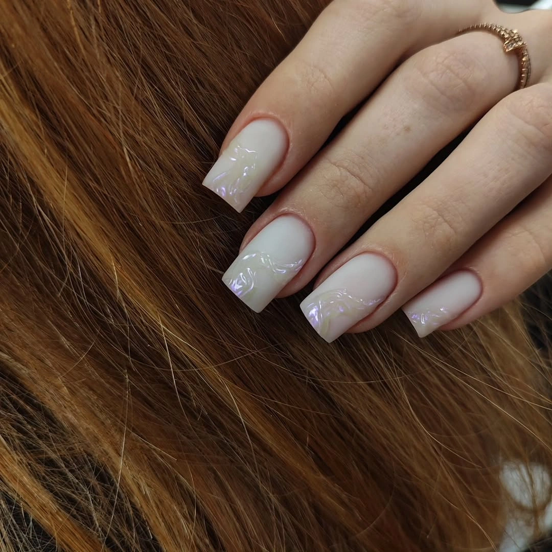 Milky square nails with iridescent raised swirls