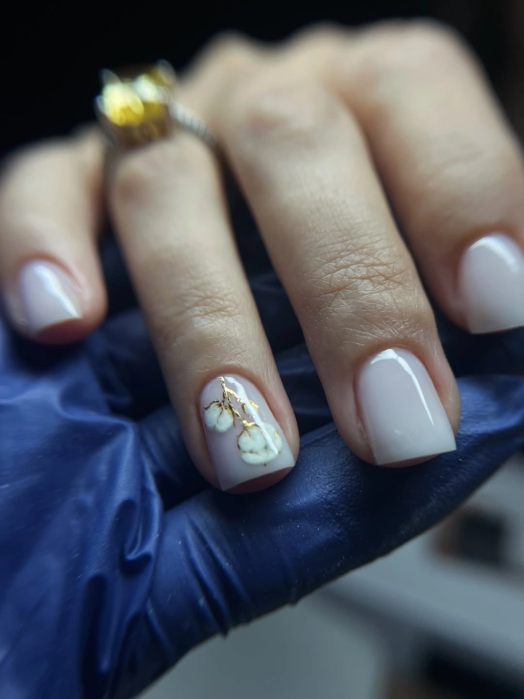 Neutral square nails with cotton floral accent