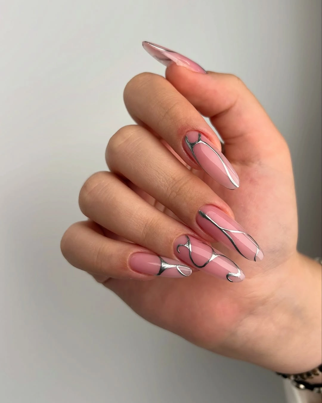 Blush almond nails with silver contour lines