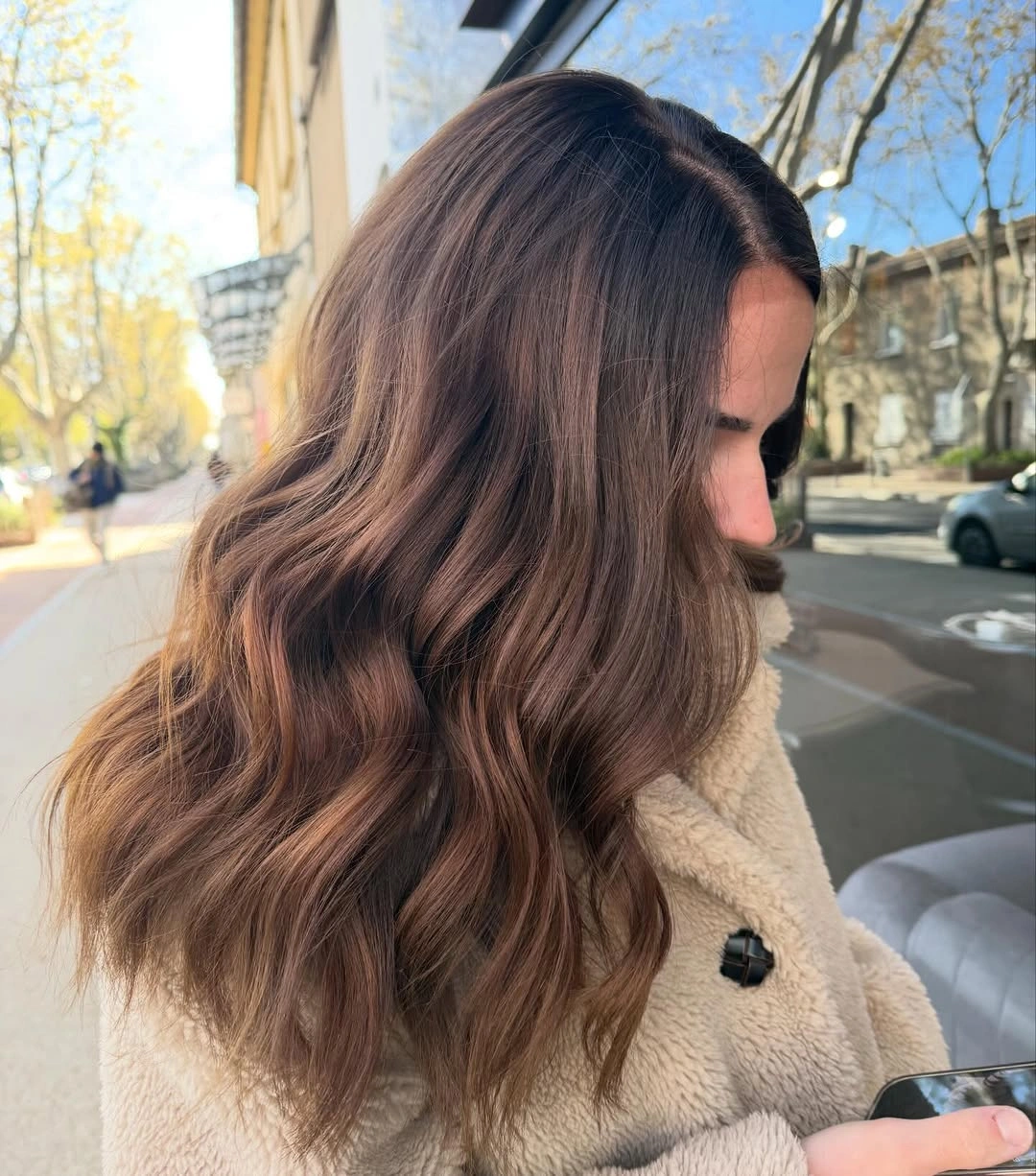 Warm brown side-parted hair with relaxed waves