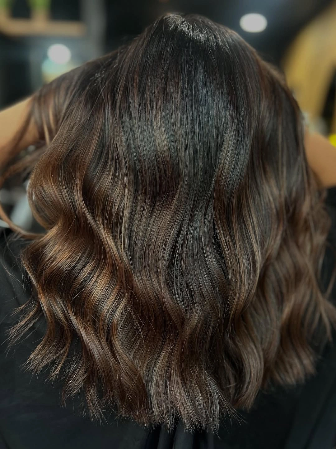 Deep brunette waves with fine caramel ribbons