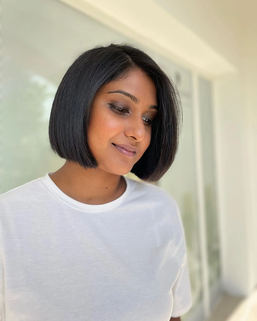 Sleek short brunette bob with a clean blunt outline