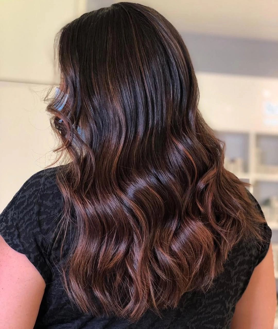 Long warm brunette waves with glossy dimensional ribbons