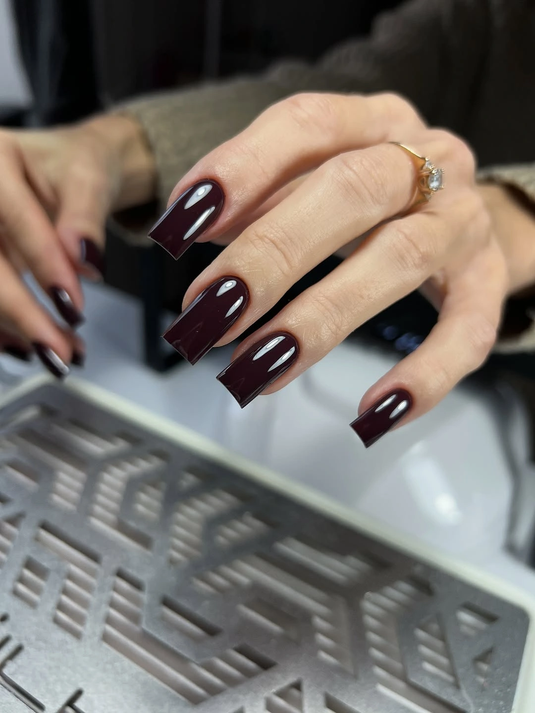 Long glossy burgundy square nails with strong architectural tips