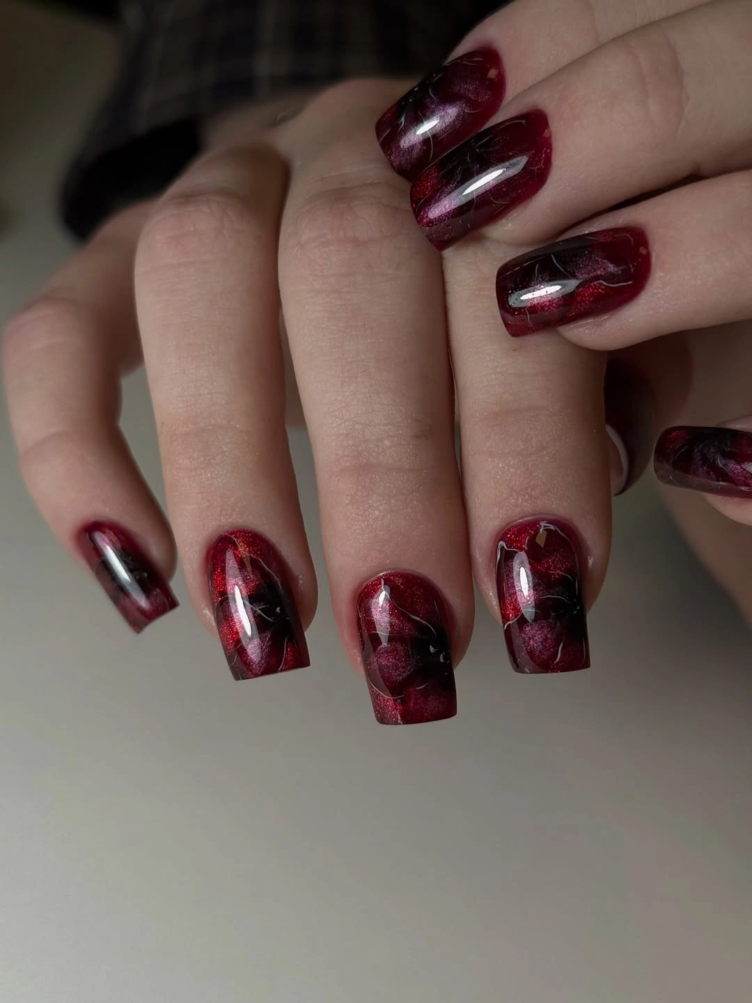 Short burgundy square nails with deep red tone on tone marbling