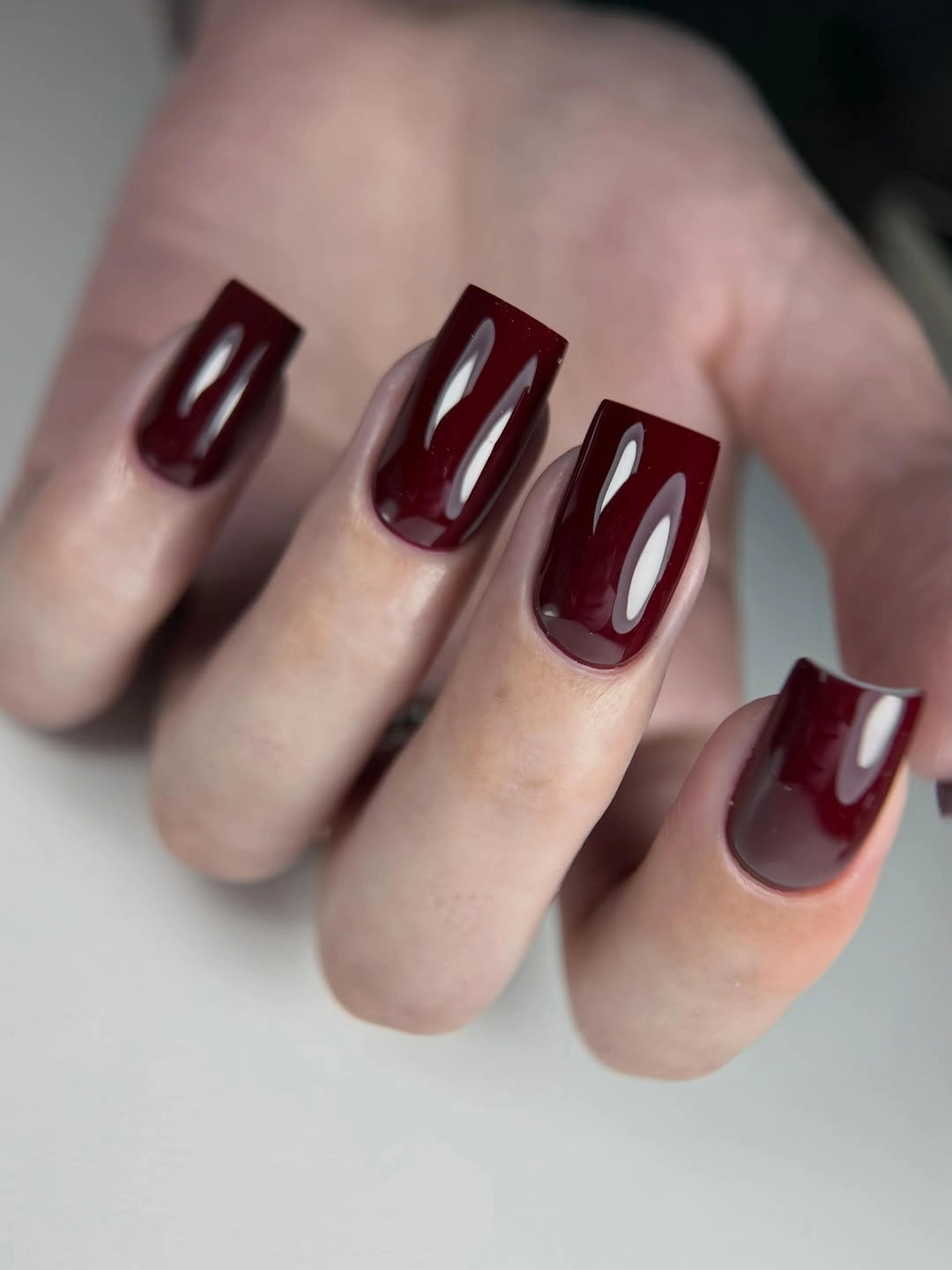 Long burgundy square nails with elongated light reflective panels