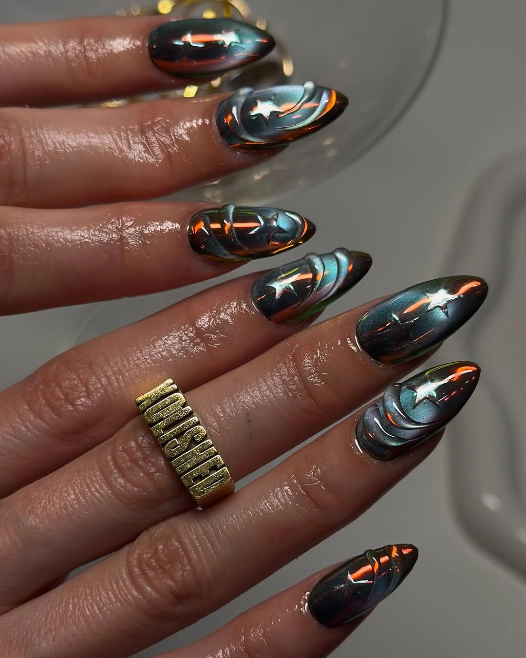 Reflective green almond nails with luminous darker edges