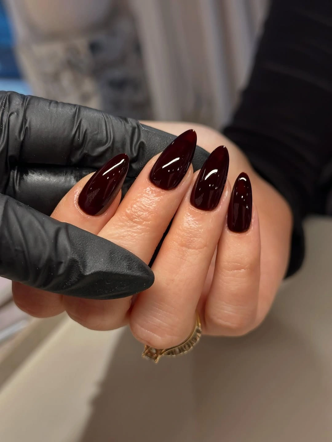 Deep burgundy almond nails with smooth glossy finish