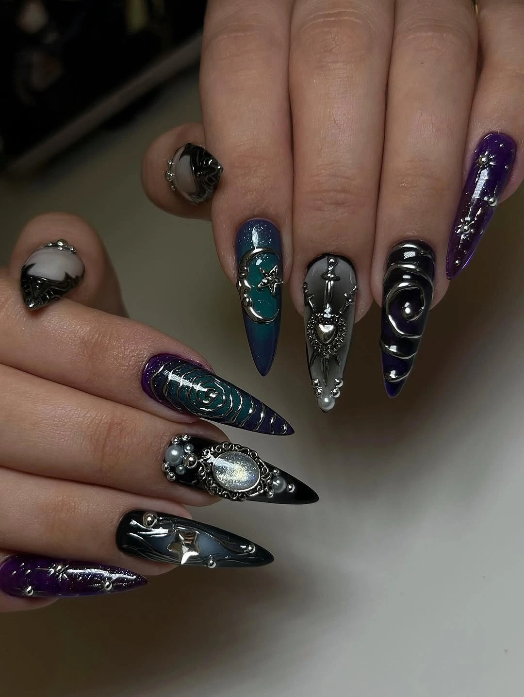 Black almond nails with narrow red orange reflective centers