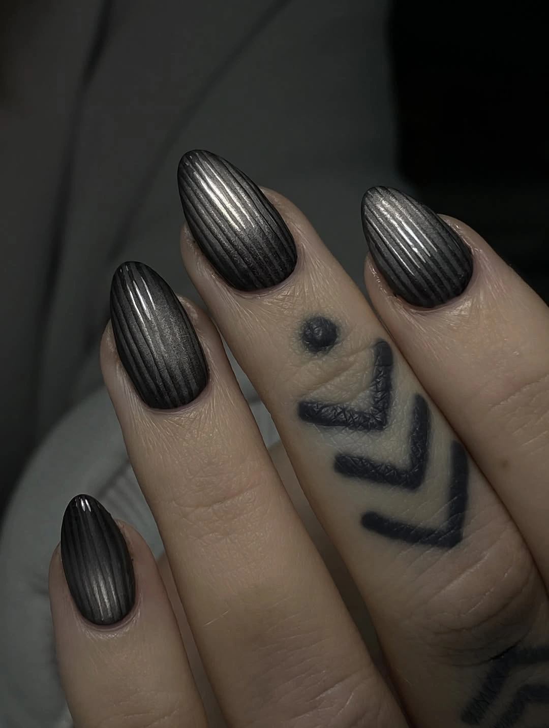 Dark metallic rounded nails with steel center highlights