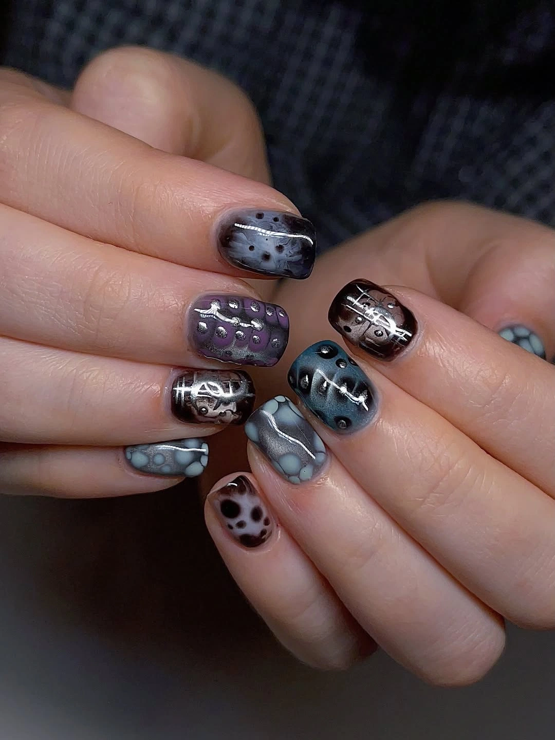 Slate blue short nails with tiny silver black graphic motifs
