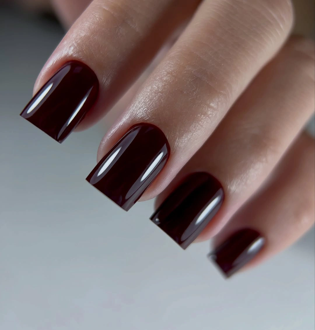 Pointed brown nails with pale leopard panels and gold borders