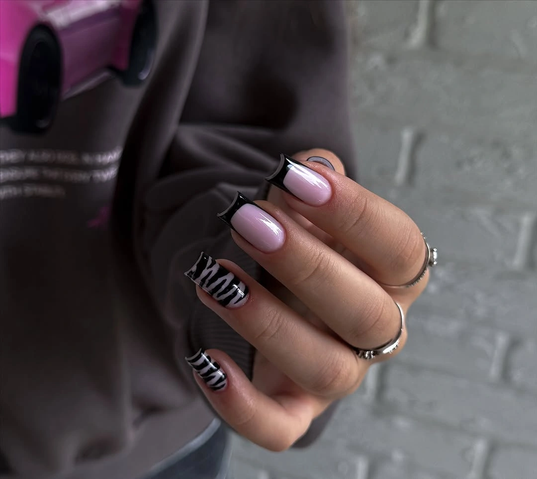 Long pale pink nails with dark line accents