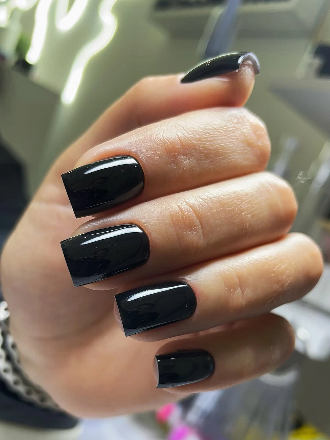 Medium square black nails with strong glossy reflections
