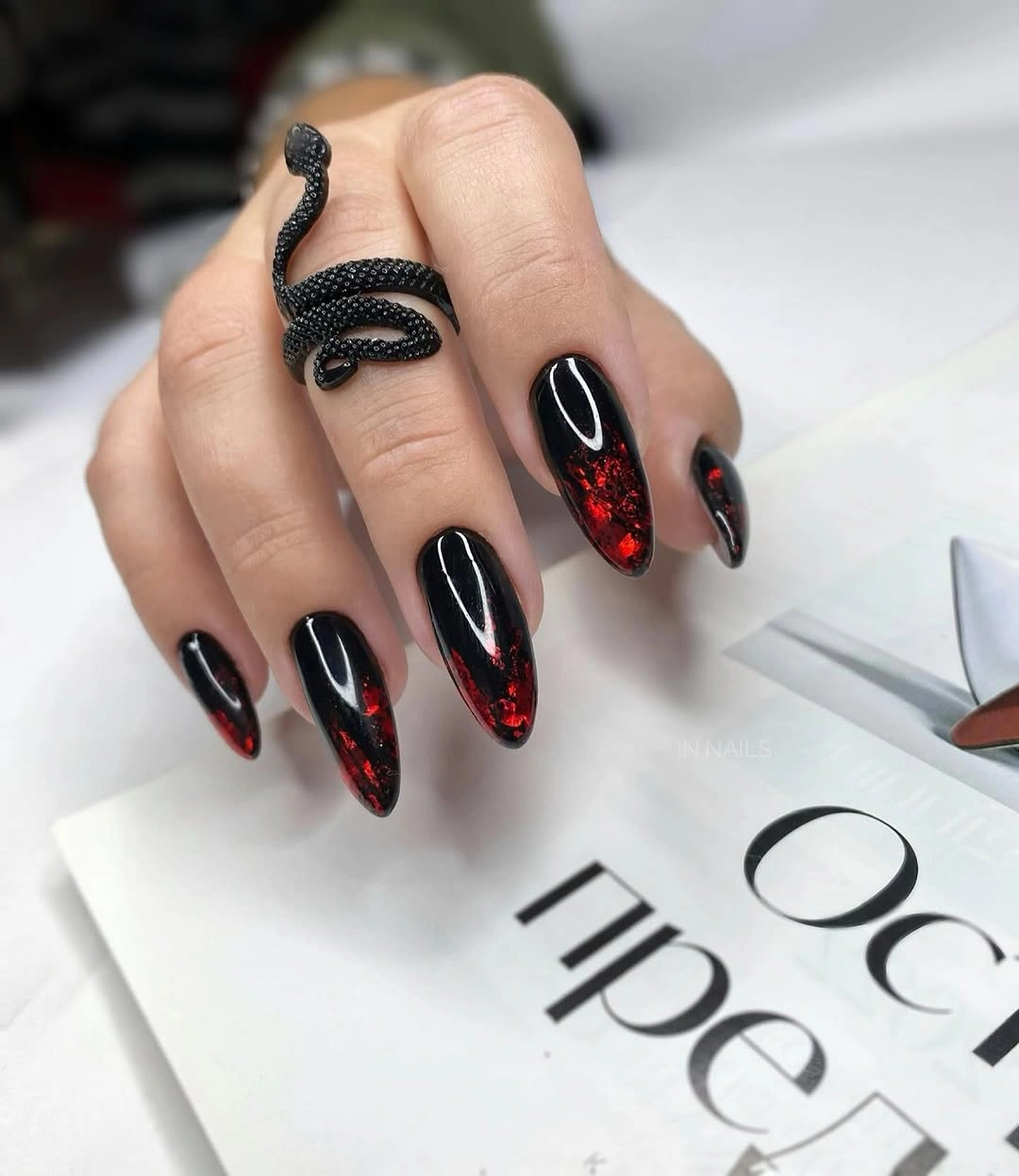Long black almond nails with red accents