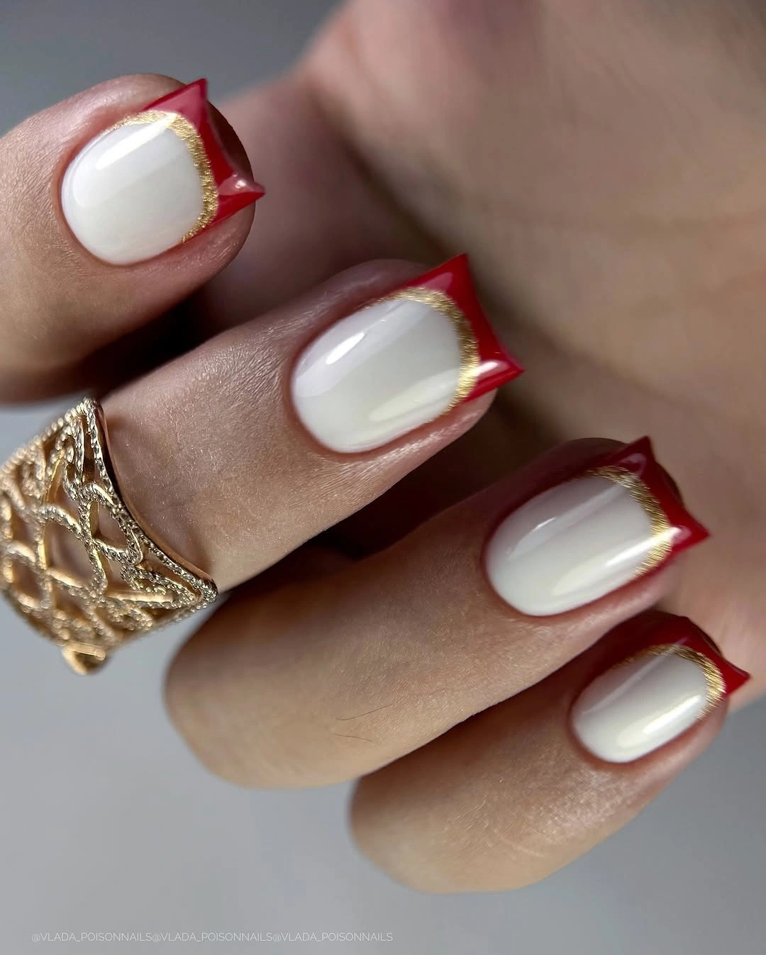 white square nails with red tips outlined in gold