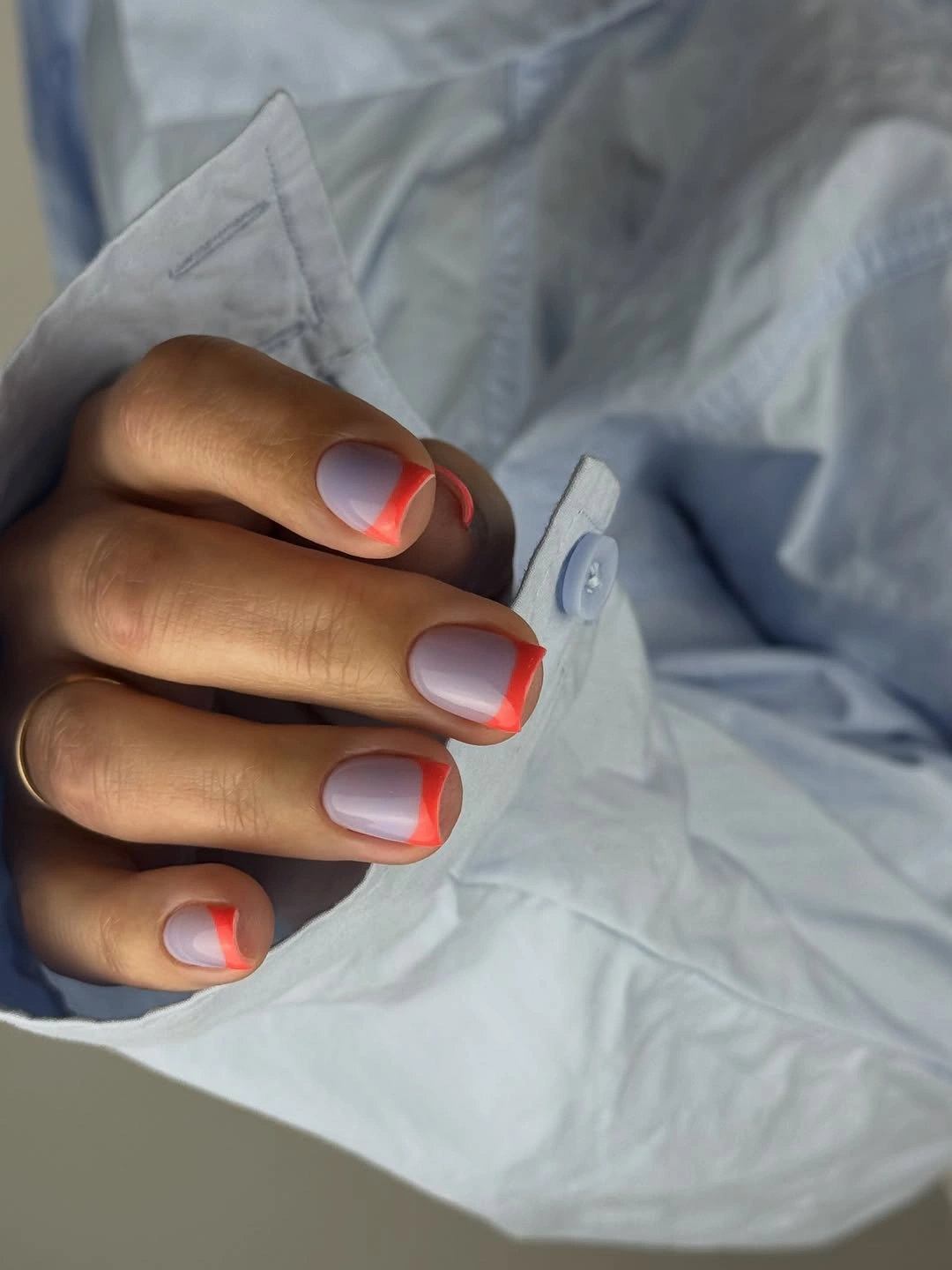 long pink square nails with vivid orange outlined tips