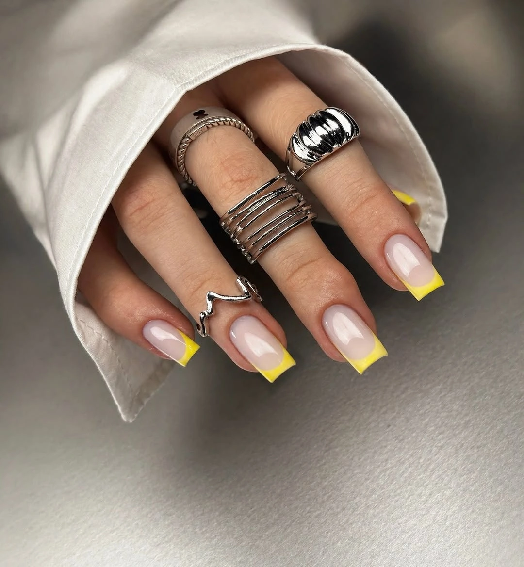 pale pink square nails with saturated yellow French tips