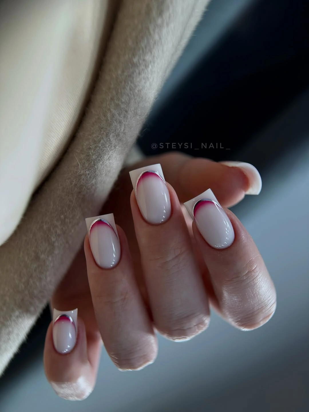 short pink nails bordered by a fine red French outline