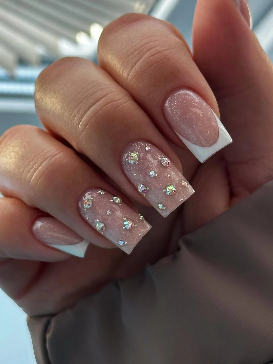 blush square nails with white tips and sparkling floral accents