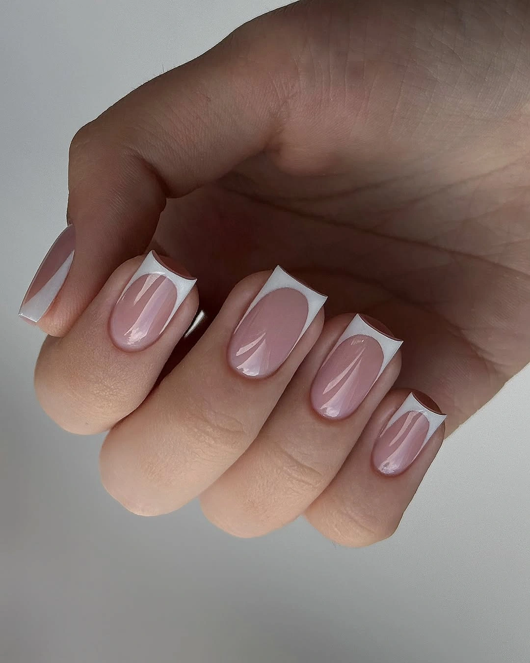 sheer pink almond nails with angled white French framing