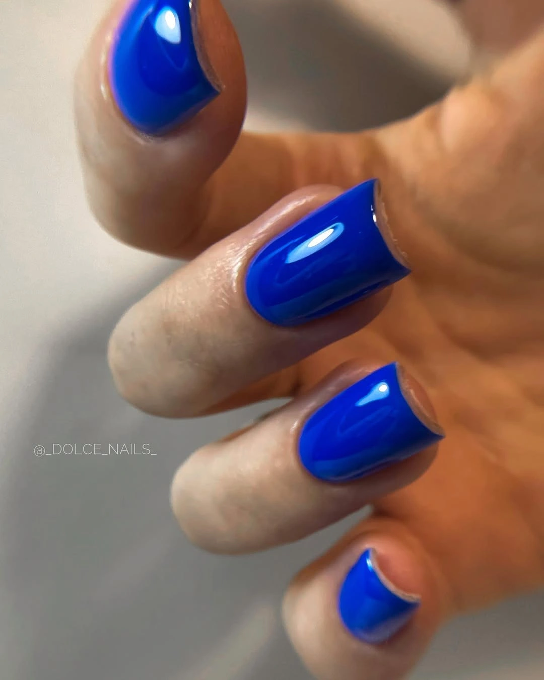 Medium rounded-square nails in glossy vivid cobalt blue