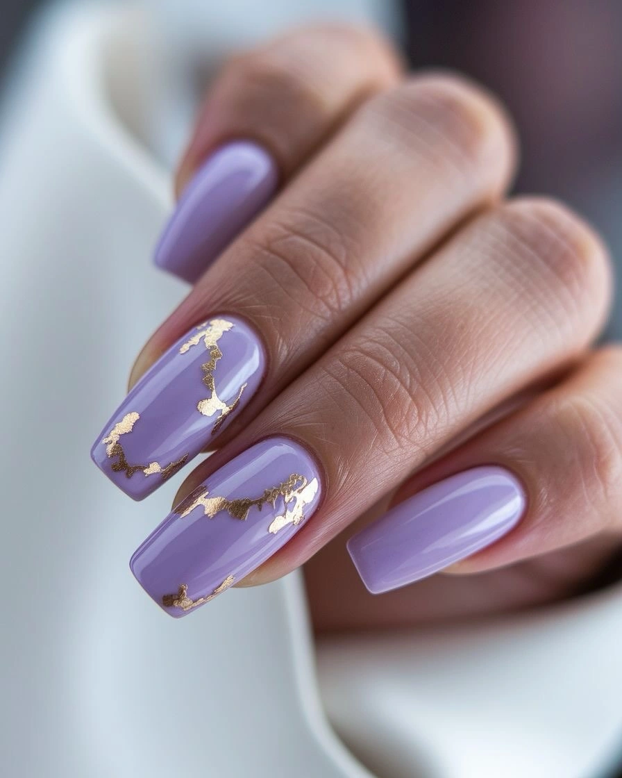 Medium lavender nails with irregular warm gold accents